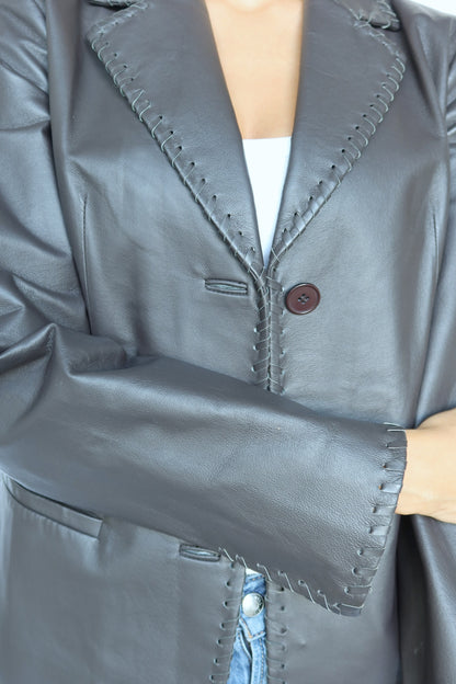 Black leather whipstitch blazer, close-up of whipstitched lapel